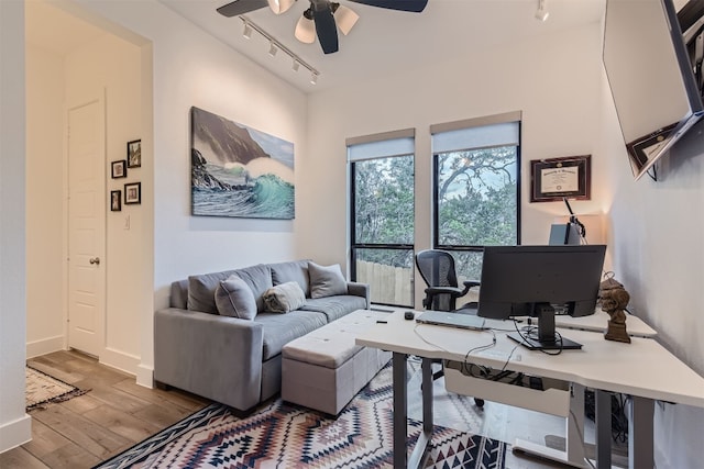 office space with light hardwood / wood-style flooring, track lighting, and ceiling fan