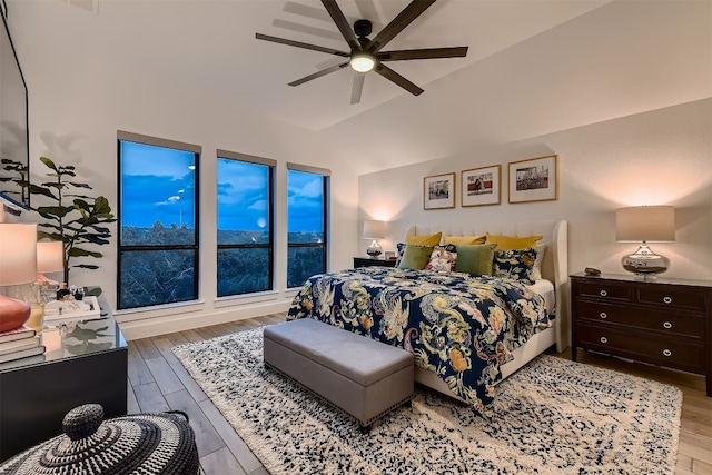 bedroom with lofted ceiling, light wood-type flooring, and ceiling fan