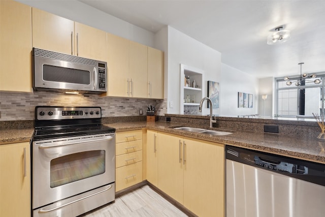 kitchen featuring appliances with stainless steel finishes, sink, decorative backsplash, an inviting chandelier, and light brown cabinets