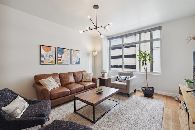 living room featuring light hardwood / wood-style floors and a chandelier