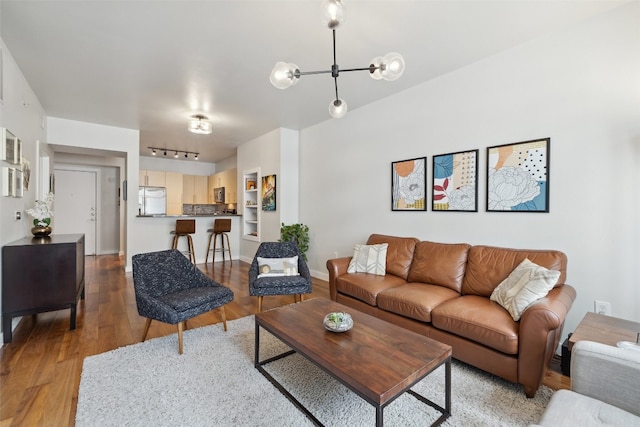 living room with a chandelier and light wood-type flooring