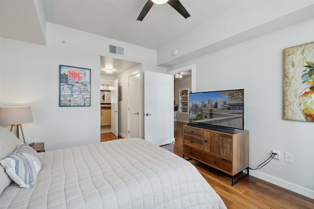 bedroom featuring light hardwood / wood-style floors, connected bathroom, and ceiling fan