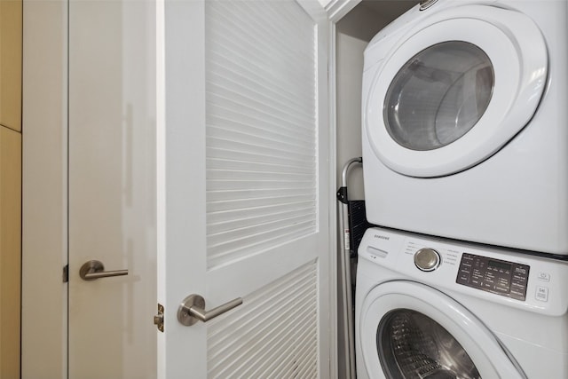 clothes washing area with stacked washer and clothes dryer