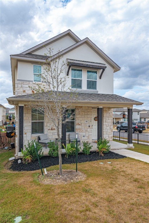 front of property featuring covered porch and a front yard