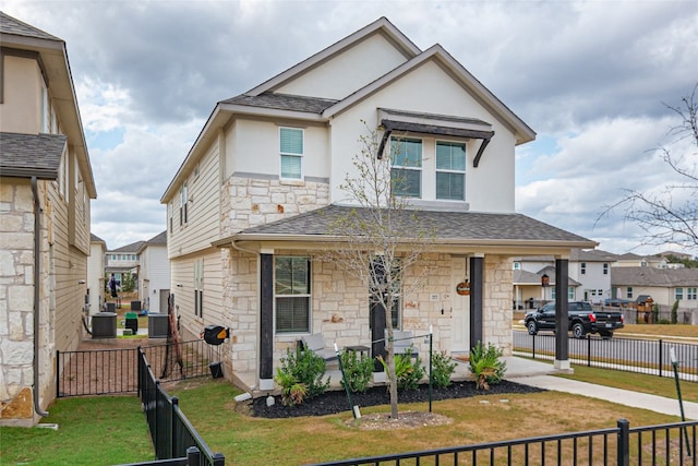 view of front of property with a porch, central air condition unit, and a front lawn