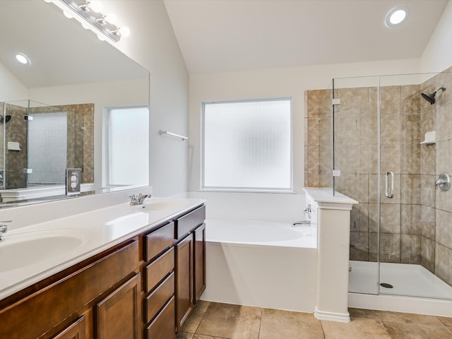 bathroom with vanity, lofted ceiling, a healthy amount of sunlight, and separate shower and tub