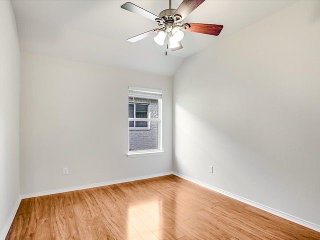 spare room featuring light hardwood / wood-style flooring, lofted ceiling, and ceiling fan