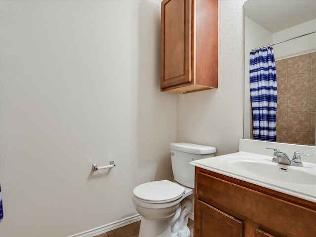 bathroom with vanity, toilet, walk in shower, and tile patterned flooring