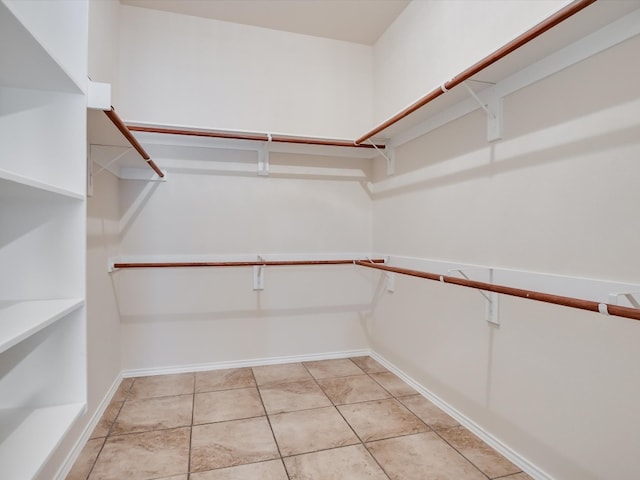 walk in closet with light tile patterned flooring