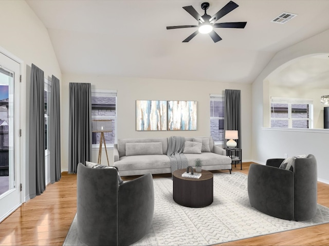 living room featuring ceiling fan, hardwood / wood-style flooring, and vaulted ceiling