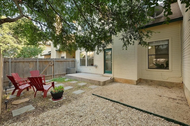 back of property featuring fence, a patio, and central AC unit