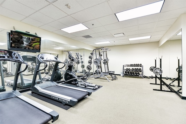 gym featuring carpet flooring and a paneled ceiling