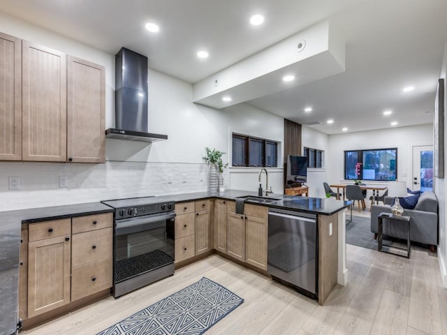 kitchen featuring light wood-type flooring, wall chimney exhaust hood, sink, electric range, and dishwasher