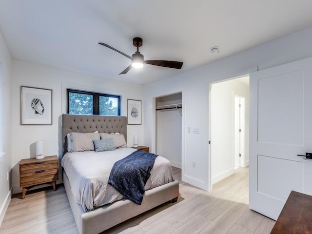 bedroom with ceiling fan, light hardwood / wood-style flooring, and a closet