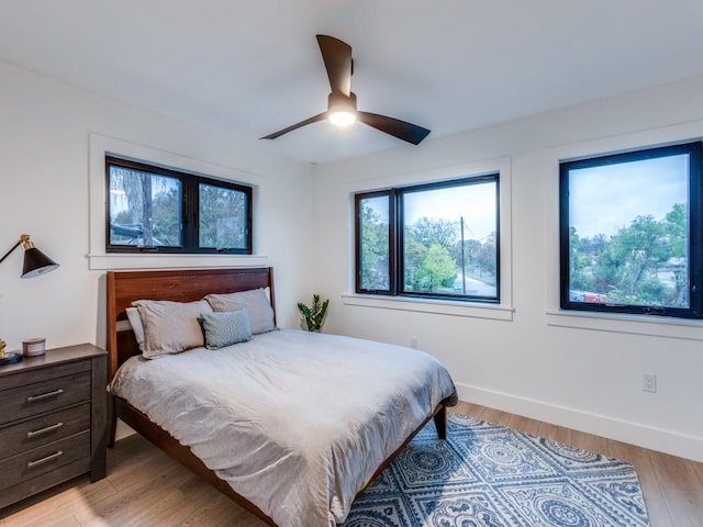 bedroom featuring light hardwood / wood-style flooring and ceiling fan