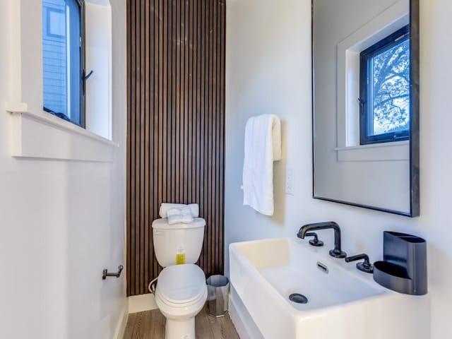 bathroom with hardwood / wood-style flooring, toilet, and sink