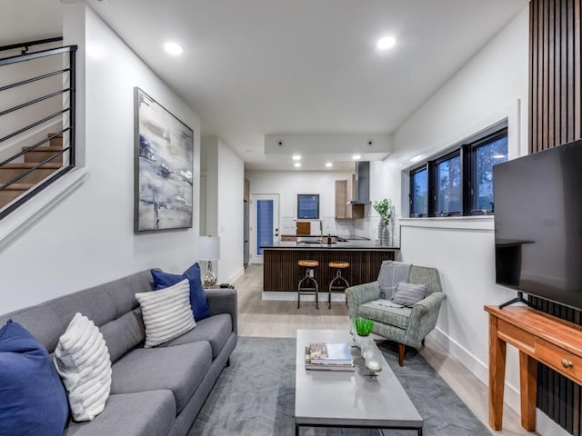 living room with light wood-type flooring and sink