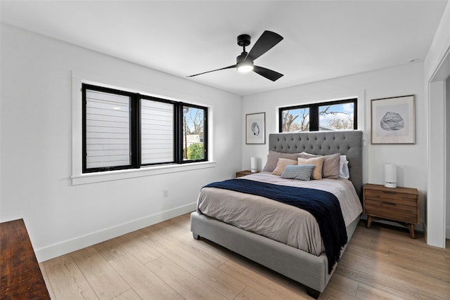 bedroom with ceiling fan and light hardwood / wood-style floors