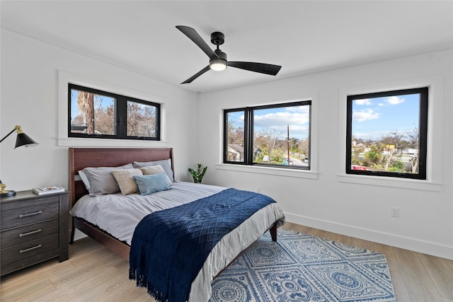 bedroom with ceiling fan and light hardwood / wood-style floors