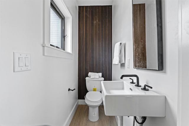 bathroom featuring toilet, hardwood / wood-style flooring, and sink