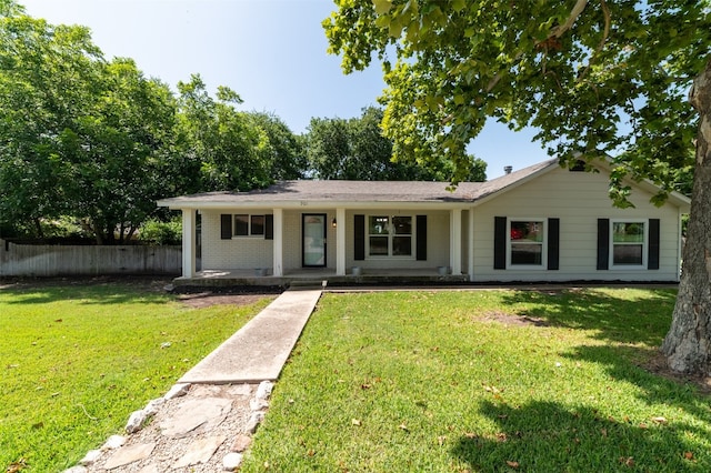 single story home featuring a porch and a front lawn