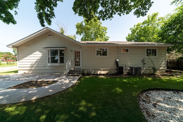 back of house with a yard and cooling unit