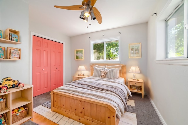 bedroom with a closet, light colored carpet, and ceiling fan