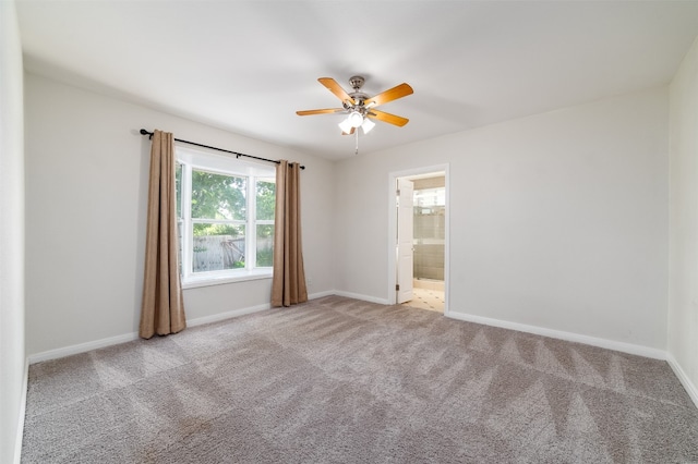 empty room featuring light colored carpet and ceiling fan