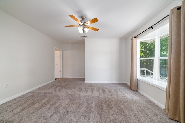 unfurnished room with light carpet and ceiling fan