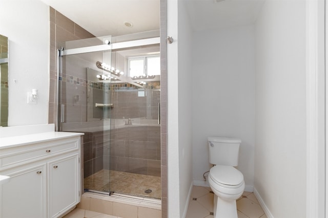 bathroom with vanity, toilet, tile patterned floors, and a shower with door