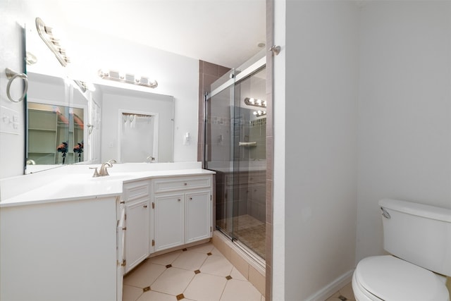 bathroom with vanity, toilet, and an enclosed shower