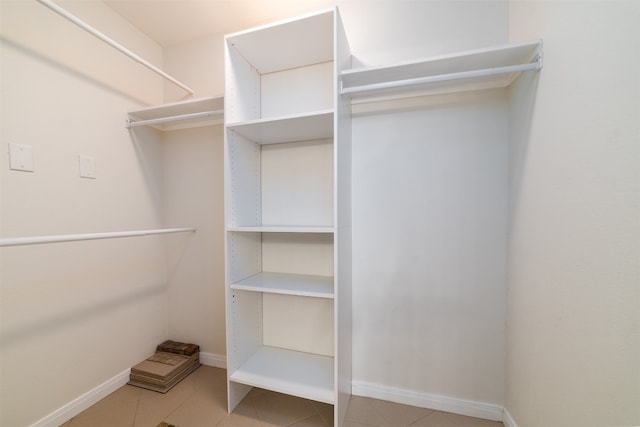 spacious closet with tile patterned floors