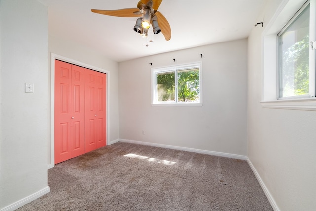 unfurnished bedroom with a closet, ceiling fan, and carpet flooring