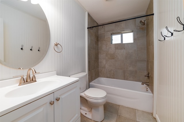 full bathroom featuring vanity, tiled shower / bath combo, toilet, and tile patterned flooring