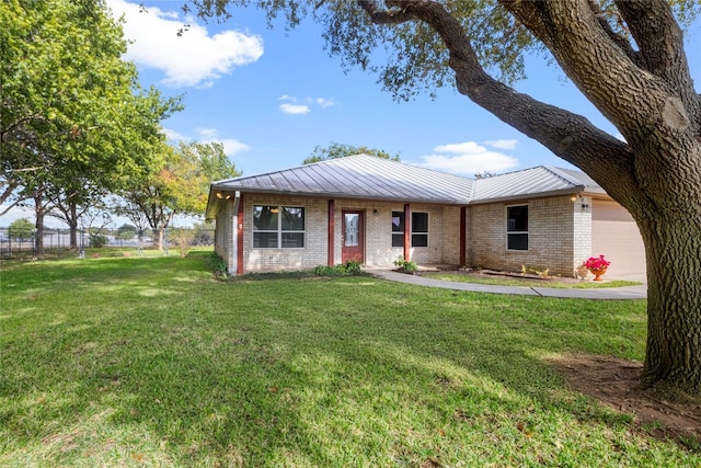 single story home featuring a front yard and a garage