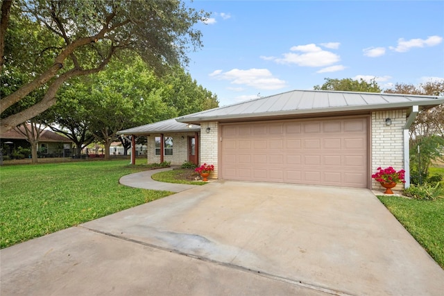 view of front of property featuring a garage and a front lawn