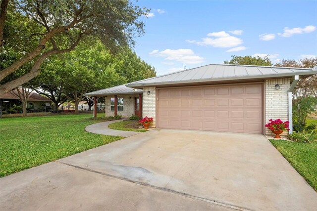 116 Wren St, Highland Haven, TX 78654 - ranch-style home with brick siding, a front yard, driveway, and an attached garage