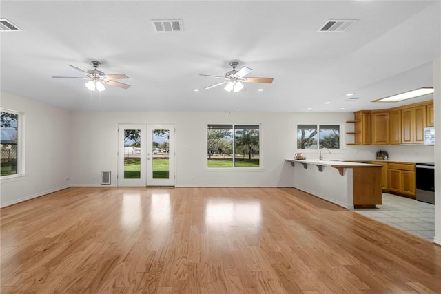 116 Wren St, Highland Haven, TX 78654 - kitchen featuring open shelves, range, a kitchen breakfast bar, a ceiling fan, and recessed lighting