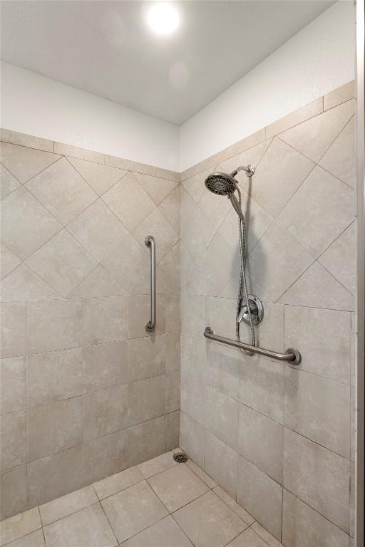 bathroom featuring tile patterned floors and a tile shower