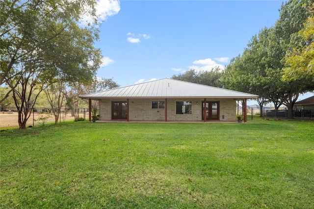 rear view of house with a yard