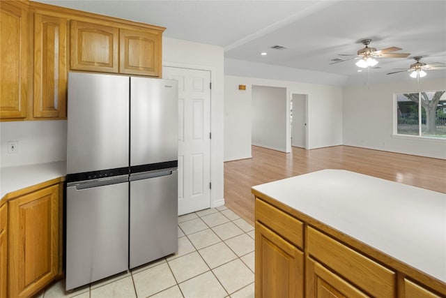 kitchen featuring light hardwood / wood-style floors, stainless steel refrigerator, and ceiling fan