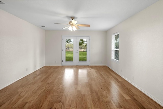 spare room featuring french doors, light hardwood / wood-style flooring, and ceiling fan