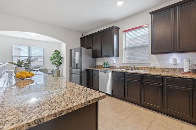 1336 Twin Estates Dr, Kyle, TX 78640 - kitchen with a sink, appliances with stainless steel finishes, arched walkways, plenty of natural light, and recessed lighting