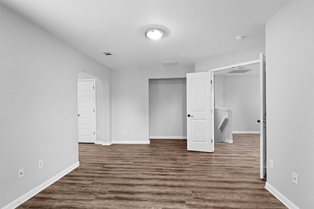 unfurnished bedroom with a closet and dark hardwood / wood-style floors