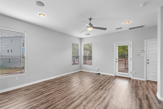 empty room with ceiling fan and hardwood / wood-style flooring