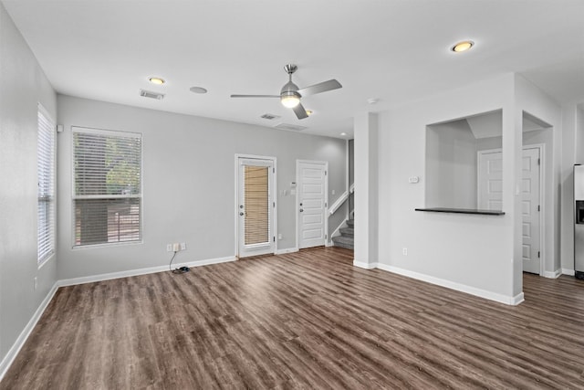 unfurnished living room with dark hardwood / wood-style floors and ceiling fan