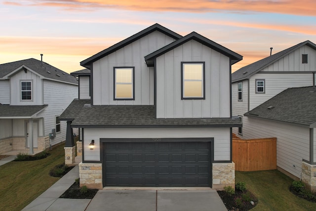 view of front of property with a yard and a garage