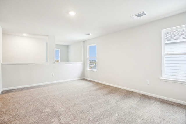 unfurnished room with a healthy amount of sunlight and carpet