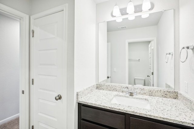 bathroom with vanity and toilet