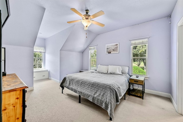 carpeted bedroom featuring ceiling fan and lofted ceiling